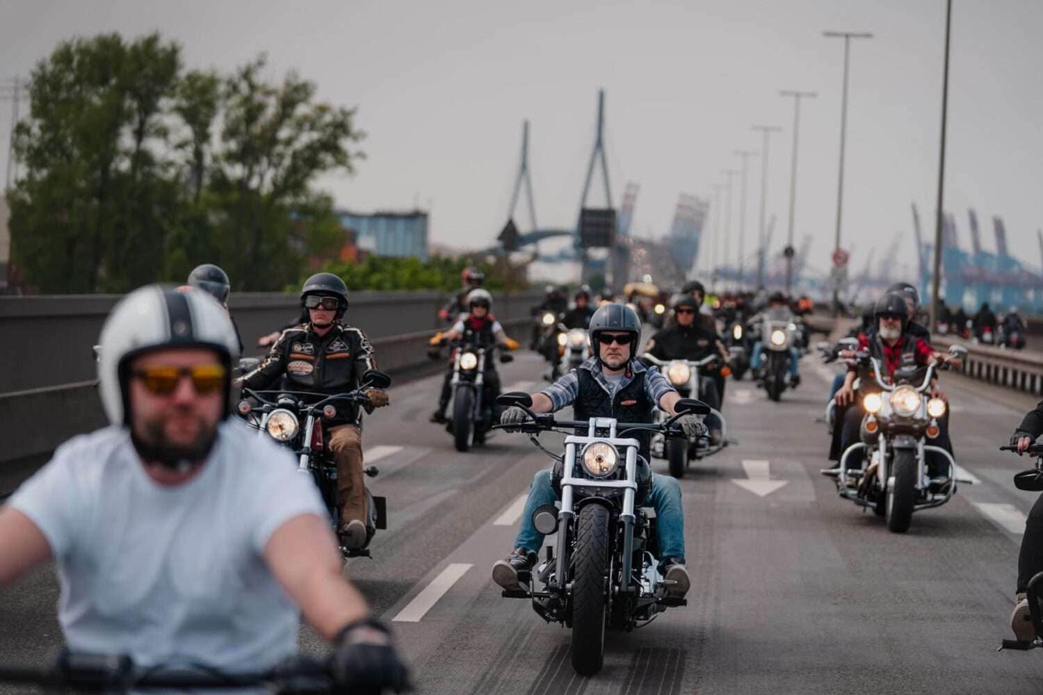 a group of people on motorcycles on a road. Parade Hamburg Harley Days