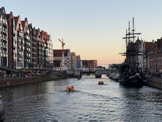 Mit der CVO Street Glide 2025 quer durch Polen Hafenansicht mit historischen Schiffen.